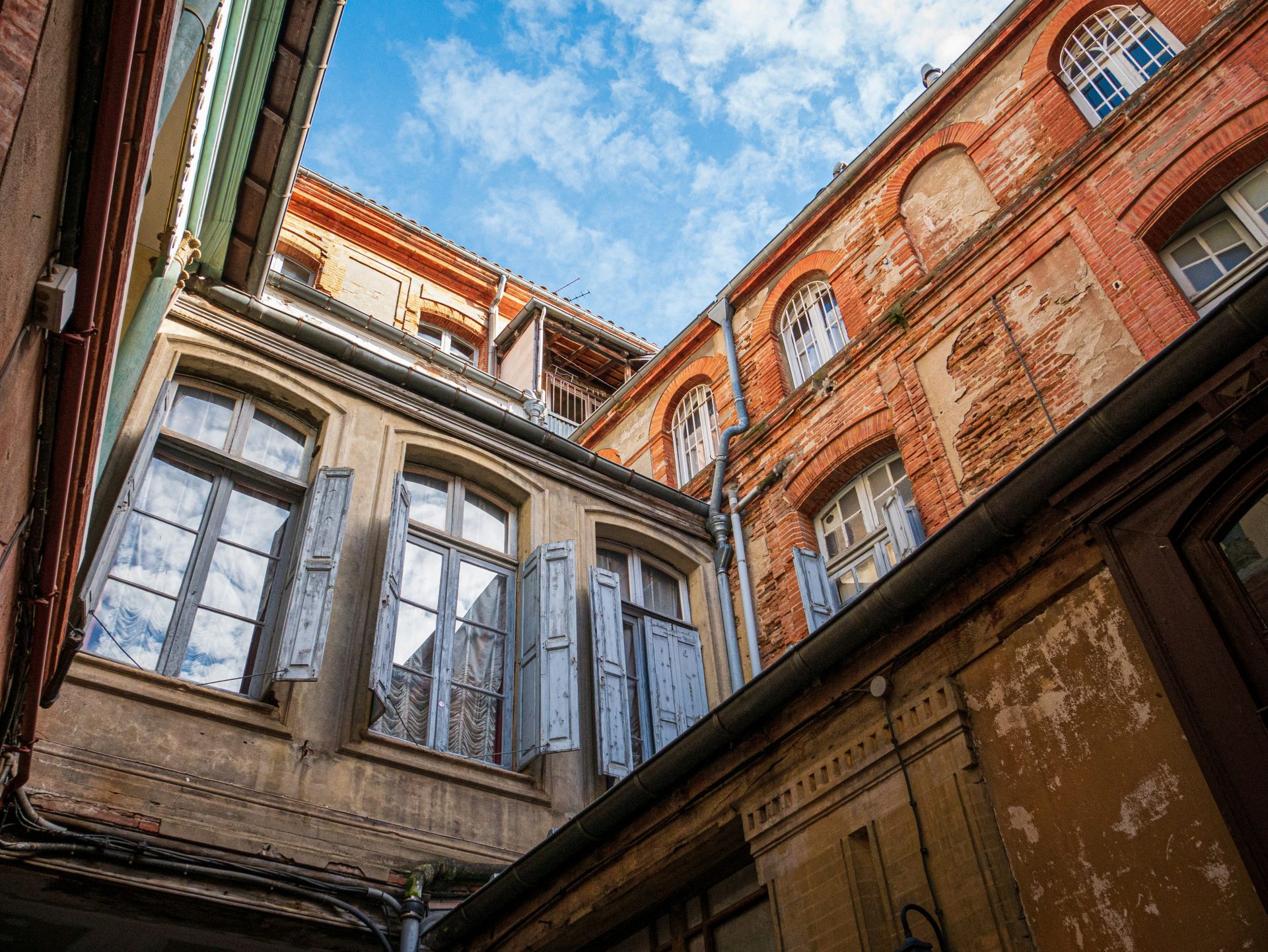 an old building with windows and a sky background